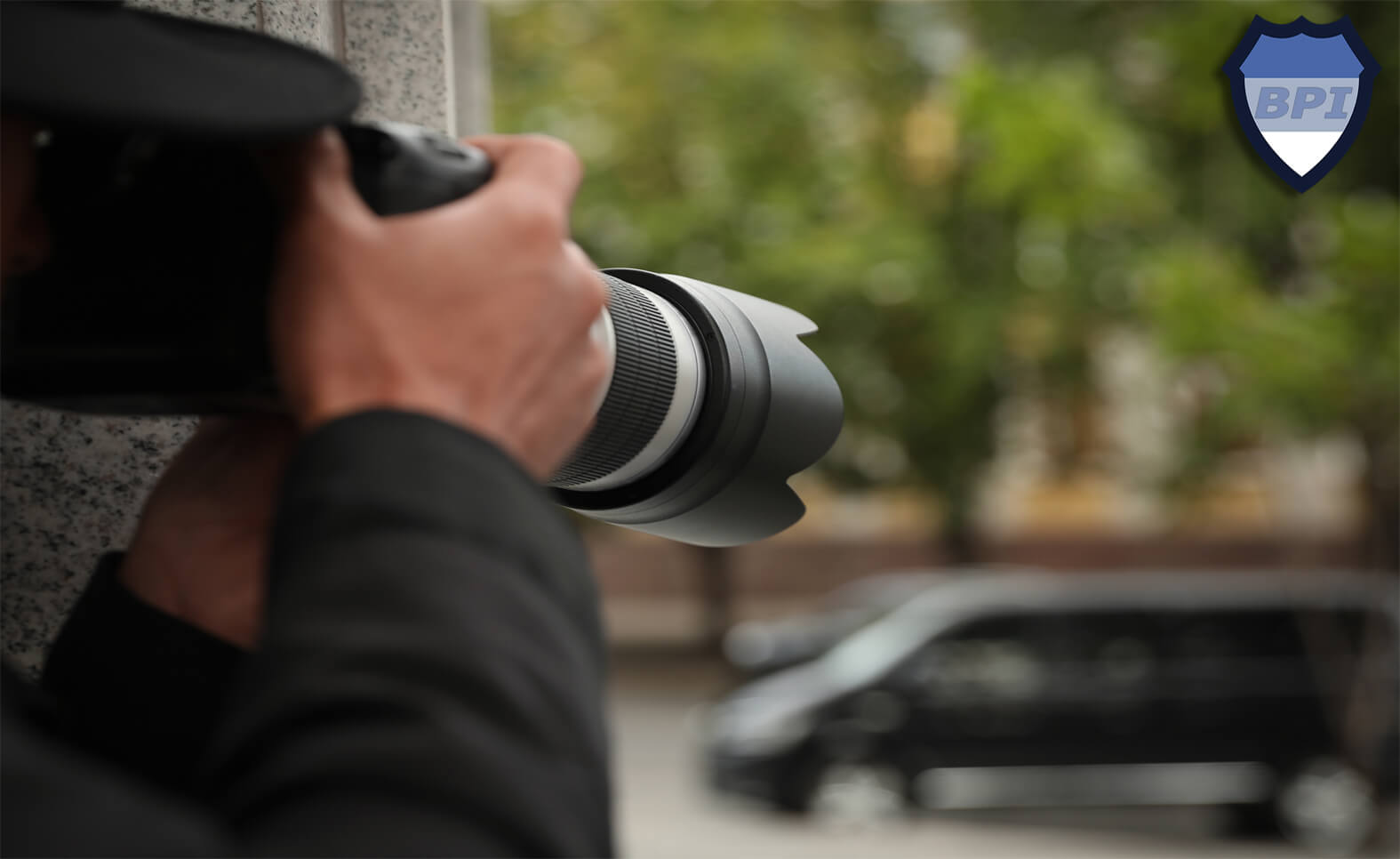 Private investigator taking photos with a DSLR camera