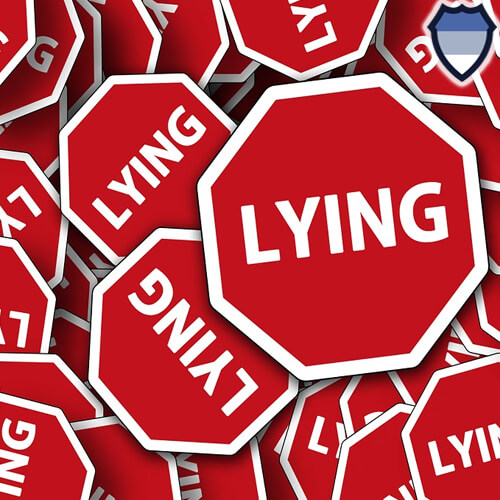 Red signs which feature the word "LYING"