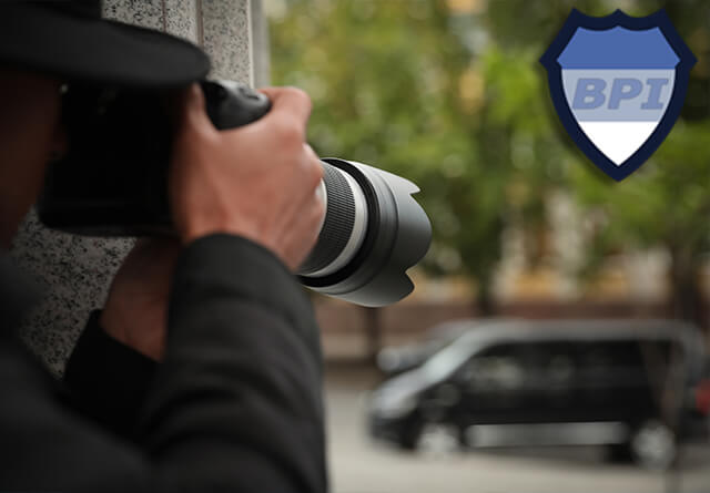 Private investigator taking photos with a DSLR camera