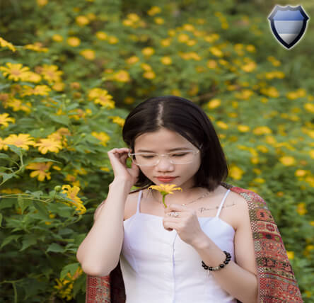 Asian lady smelling a flower