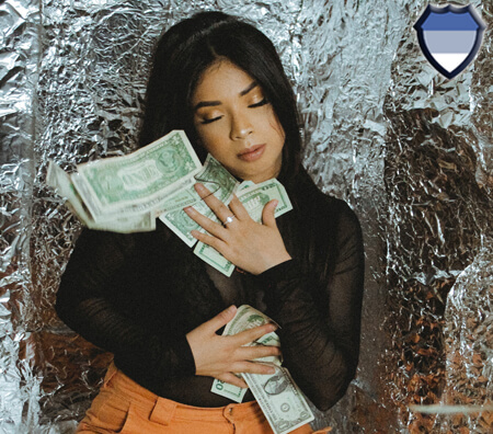 A lady clutching dollar bills