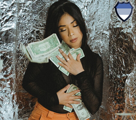 A lady clutching dollar bills