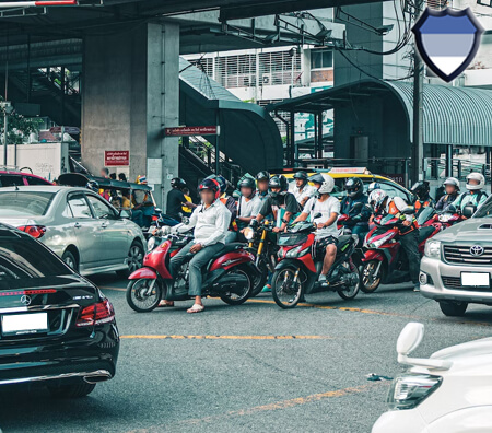 Cars and motorbikes on a busy road in Thailand