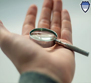 Magnifying glass in the palm of a hand