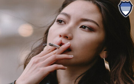 Asian woman smoking a cigarette