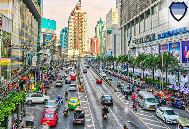 Cars and motorbikes driving on a road in the metropolitan Bangkok area